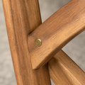 Macro | acacia crossed side-brace join with a round brass-toned fastener