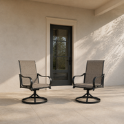 Scale view | two brown sling swivel dining armchairs beside an uncropped full-height exterior door