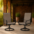 Brick loggia | two brown sling swivel dining armchairs beneath a timber pergola with terracotta pots
