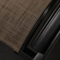 Close detail | brown sling cross-hatch weave beside the black frame edge