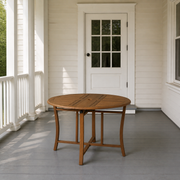 Scale | Open folding table on a covered white porch with a full-height doorway behind it