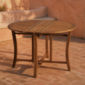 Room | Open eucalyptus folding table on a terracotta courtyard with brick paving and a plaster bench