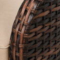 Wicker weave detail | Close macro of the variegated brown PE-wicker diagonal basket weave on the chair's curved frame, with beige cushion fabric entering at lower left