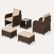 Side and rear studio view | two chairs, two ottomans, and glass-top table with chair backs visible
