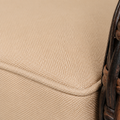 Fabric macro | solid beige cushion's fine basket weave and matching piped edge beside brown wicker