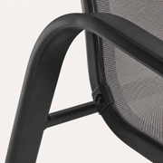 Hardware | close view of the black curved arm joint and round fastener on the gray sling chair