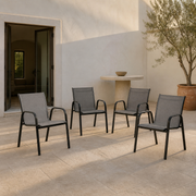 Scale | four Gray stacking armchairs standing in an open doorway for scale