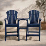 In a room | Two navy blue HDPE bar-height Adirondack chairs joined by a two-tier tray on pale limestone, olive in a terracotta planter