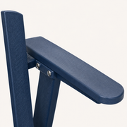 Close view | Navy molded HDPE woodgrain texture on a rounded arm and back slat