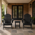 In a room | brick porch with two black Adirondack chairs and black square side table