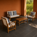 Terracotta courtyard | complete acacia loveseat, two club chairs, and coffee table in a shaded courtyard
