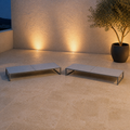 Set | two flat pale-gray mesh chaise lounges on a roof terrace