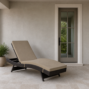 Scale | chaise lounge beside a full-height black exterior door for scale