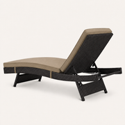 Side | rear studio view of the dark woven chaise lounge with the raised back and support braces