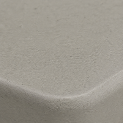 Texture | tight macro of the light-gray speckled surface and molded edge