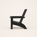 Side | black HDPE Adirondack chair in a true side profile showing the raked back, seat depth, and curved rear legs