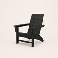 Studio | black HDPE Adirondack chair at a three-quarter studio angle showing its slatted back and flared rear legs