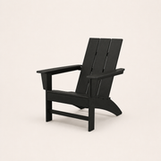 Studio | black HDPE Adirondack chair at a three-quarter studio angle showing its slatted back and flared rear legs