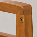 Close view | brass-toned circular fastener at an acacia arm and front-leg joint