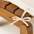 Hardware | macro detail of acacia folding joint, ivory cushion tie, and recessed fastener