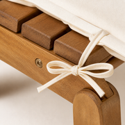 Hardware | macro detail of acacia folding joint, ivory cushion tie, and recessed fastener