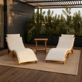 In a room | timber-deck rooftop setting with two ivory-cushioned acacia chaise lounges and folding side table