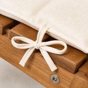 Texture | macro detail of ivory woven cushion cover, fabric tie, acacia grain, and recessed fastener