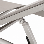 Recline hardware | hex fastener and stepped aluminum support brace beneath the light gray mesh rail