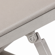 Mesh close-up | light gray fine-grid sling edge wrapped into a brushed silver aluminum rail