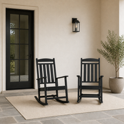 Scale | Two black rocking chairs beside a full-height exterior doorway