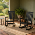 Garden veranda | Two black rocking chairs on sage walls and terracotta tile