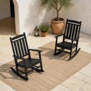 Courtyard angle | Two black rocking chairs together from a second courtyard view