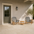 In scale | two teak Adirondack chairs and round side table beside a full-height exterior doorway