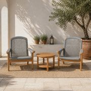 Mediterranean courtyard | two natural teak Adirondack chairs and a round slatted teak side table on pale limestone pavers