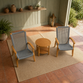 Sage veranda | two teak Adirondack chairs and a round slatted side table under warm late light