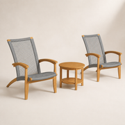 Three-quarter studio | two teak Adirondack chairs and the separate round slatted teak side table, gray woven rope visible