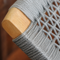 Close view | gray woven rope, raised basket weave and rounded natural teak chair arm cap