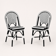 Studio | three-quarter studio view of two black-and-white woven bistro dining chairs