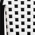 Texture | macro of the black-and-white woven reed pattern beside a black chair tube