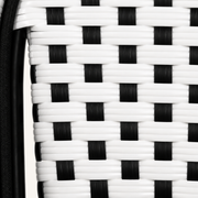 Texture | macro of the black-and-white woven reed pattern beside a black chair tube