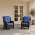 In scale | two blue-cushioned wicker patio chairs beside a fully visible exterior doorway