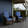 Veranda | two blue-cushioned brown wicker patio chairs beneath a pale pergola on slate pavers