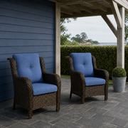 Veranda | two blue-cushioned brown wicker patio chairs beneath a pale pergola on slate pavers