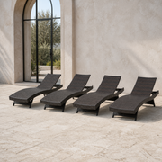 Scale | four dark brown woven folding chaise lounges beside a full-height arched glass doorway