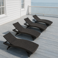 In a room | four dark brown woven folding chaise lounges on a cool coastal veranda
