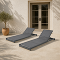 Scale | two gray mesh chaise lounges on a patio with a full-height doorway behind them