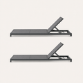Side | side studio view of two gray mesh chaise lounges with raised backrests
