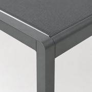 Detail | close view of the squared charcoal aluminum frame corner and grey mesh sling edge