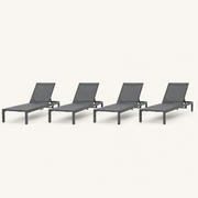 Front | four matching dark charcoal chaise lounges on a clean studio ground, with grey mesh sling seats and raised backs