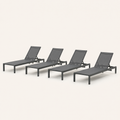 Three-quarter | four matching dark charcoal mesh sling chaise lounges from the front-right on a clean studio ground